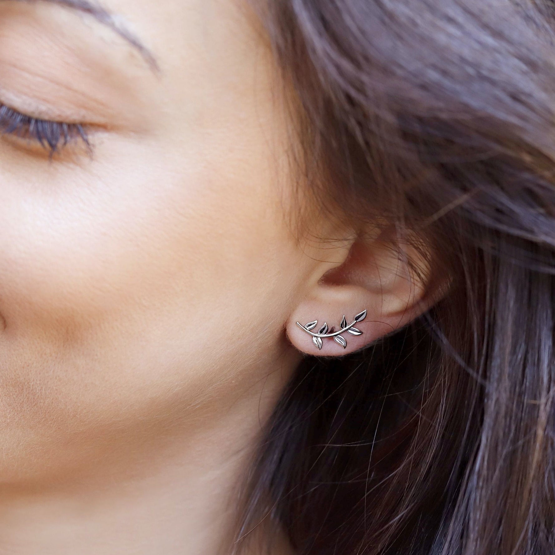 Sterling silver tiny leaves stud earrings by AJJ, featuring modern olive leaf design with a sparkling finish.