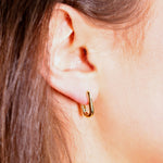 Small rectangular huggie hoops by AJJ, silver and gold geometric dainty hoop earrings, close-up view of their sleek design.