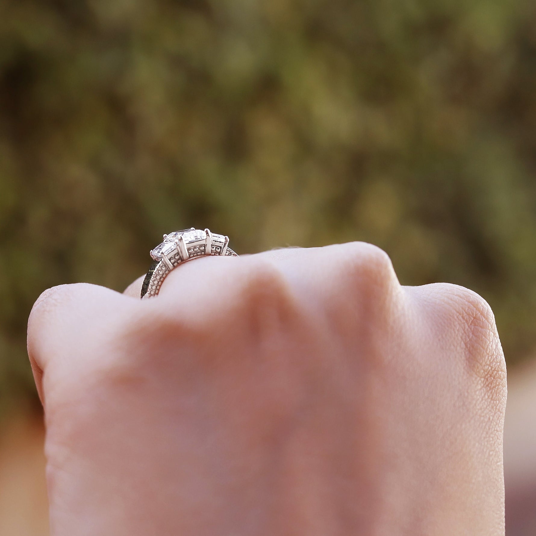 Dyla 2.5 ct emerald trilogy ring in sterling silver, showcasing a stunning design perfect for engagements or promises.