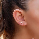 Sterling silver AJJ huggie hoop earrings with minimalist open design, close-fitting small hoops for elegant everyday wear.