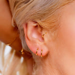 Sterling silver huggie hoop earrings by AJJ, minimalist open geometric silver hoops with a delicate, simple design.
