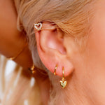 AJJ silver minimalist heart huggie hoops, small dainty silver earrings, tiny hoop earrings, helix style jewelry on model.