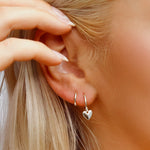 AJJ silver minimalist heart huggie hoops, small dainty earrings with tiny heart charms, perfect for everyday wear.